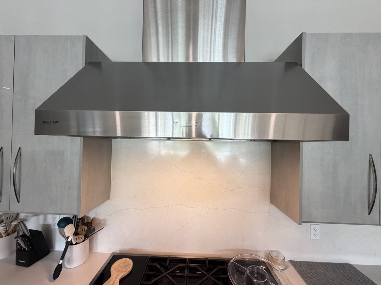 Signature Kitchen Suite premium wall range hood after touch panel replacement in Kissimmee, FL
